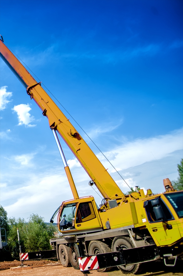 big, industrial crane moving a mobile cement plant